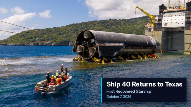 SpaceX's recovered Ship 40 Starship resting in deck cradles aboard the heavy-lift vessel Forte off Christmas Island, with a recovery crew in a small boat nearby.